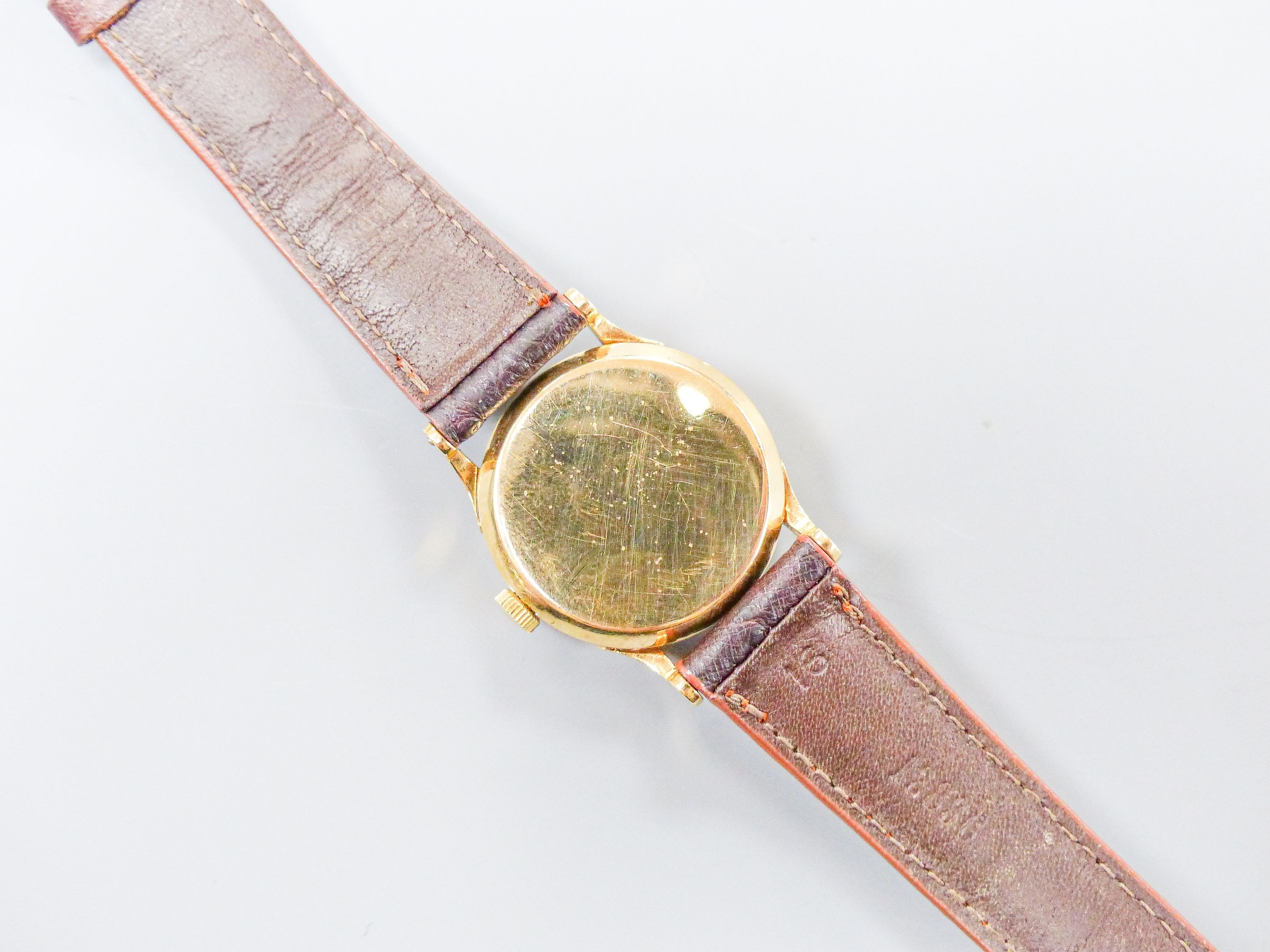 A lady's 14k Tiffany & Co manual wind wrist watch, on associated leather strap, case diameter 27mm, gross weight 28.8 grams.